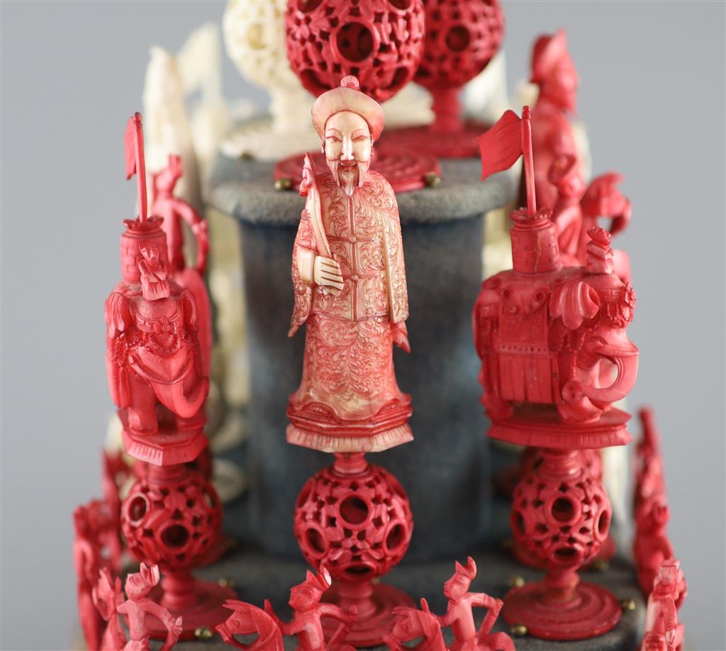 A set of 19th century Cantonese carved and red stained ivory chess pieces under dome, white king 20cm high